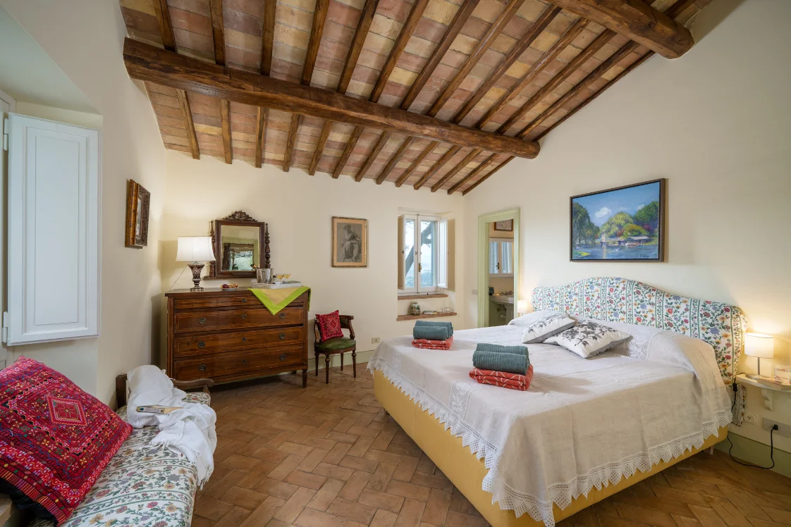 The guest house bedroom, a queen bed under the eaves