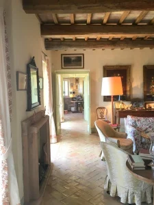 A hallway with terracotta floors connecting the ground-floor rooms