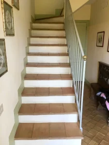 The stone staircase connecting the farmhouse's three floors